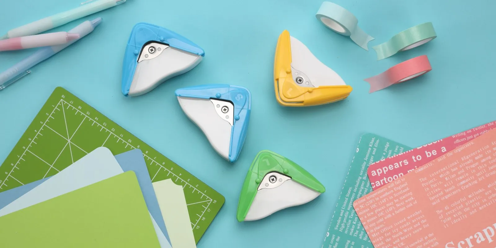 aidox 2-in-1 Corner Cutters on a desk with paper, washi tape and a cutting mat